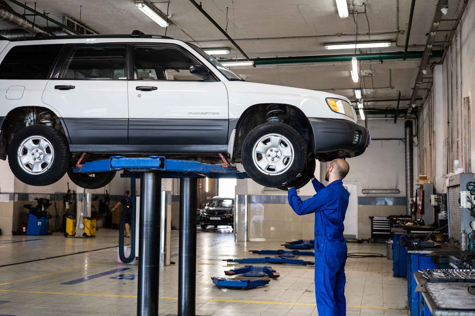 Car on a two-post lift for inspection