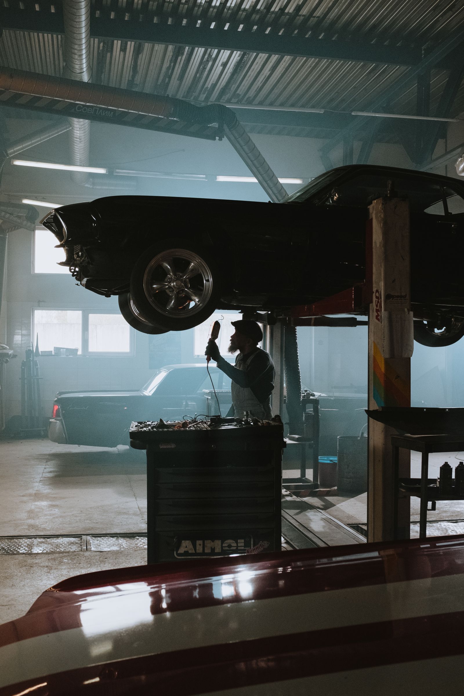 Car raised on a lift for tyre and alignment work